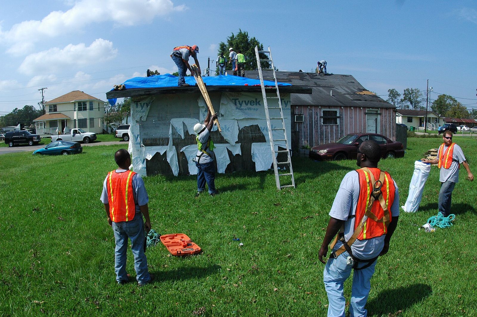 Technician photographing hail-dented siding on a house in Bradley, Illinois